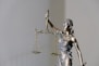 woman in dress holding sword figurine