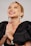 woman in black blazer with silver and white pearl earrings