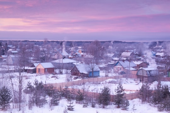 houses on snow covered ground during daytime in Karélia Russia