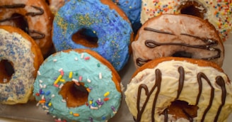A colorful assortment of mini donuts with various toppings.