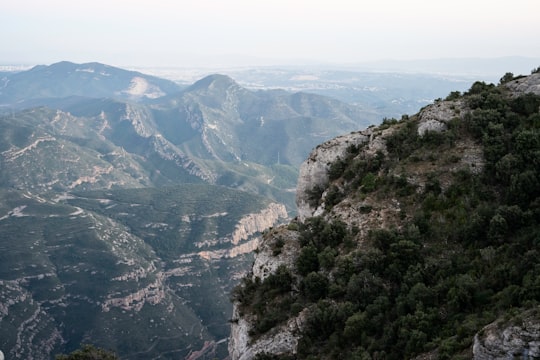 green mountains under blue sky during daytime in Montserrat Spain