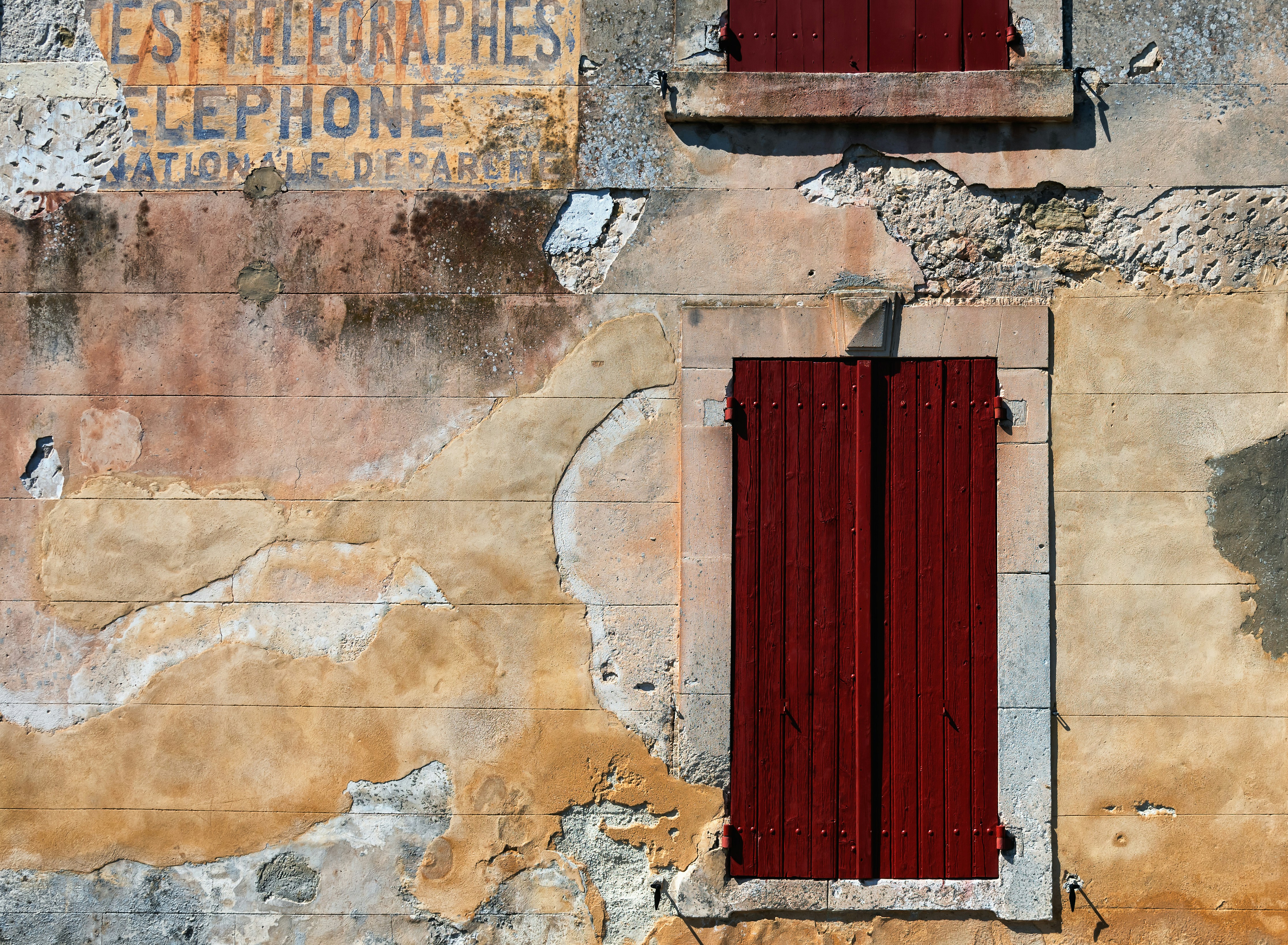 red wooden door on brown brick wall