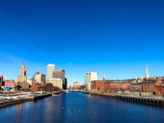 An engineer reviewing blueprints for a sustainable urban infrastructure project under bright daylight.