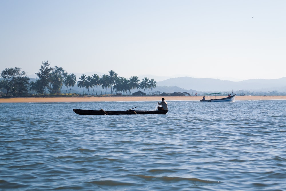 2 person riding on boat on sea during daytime