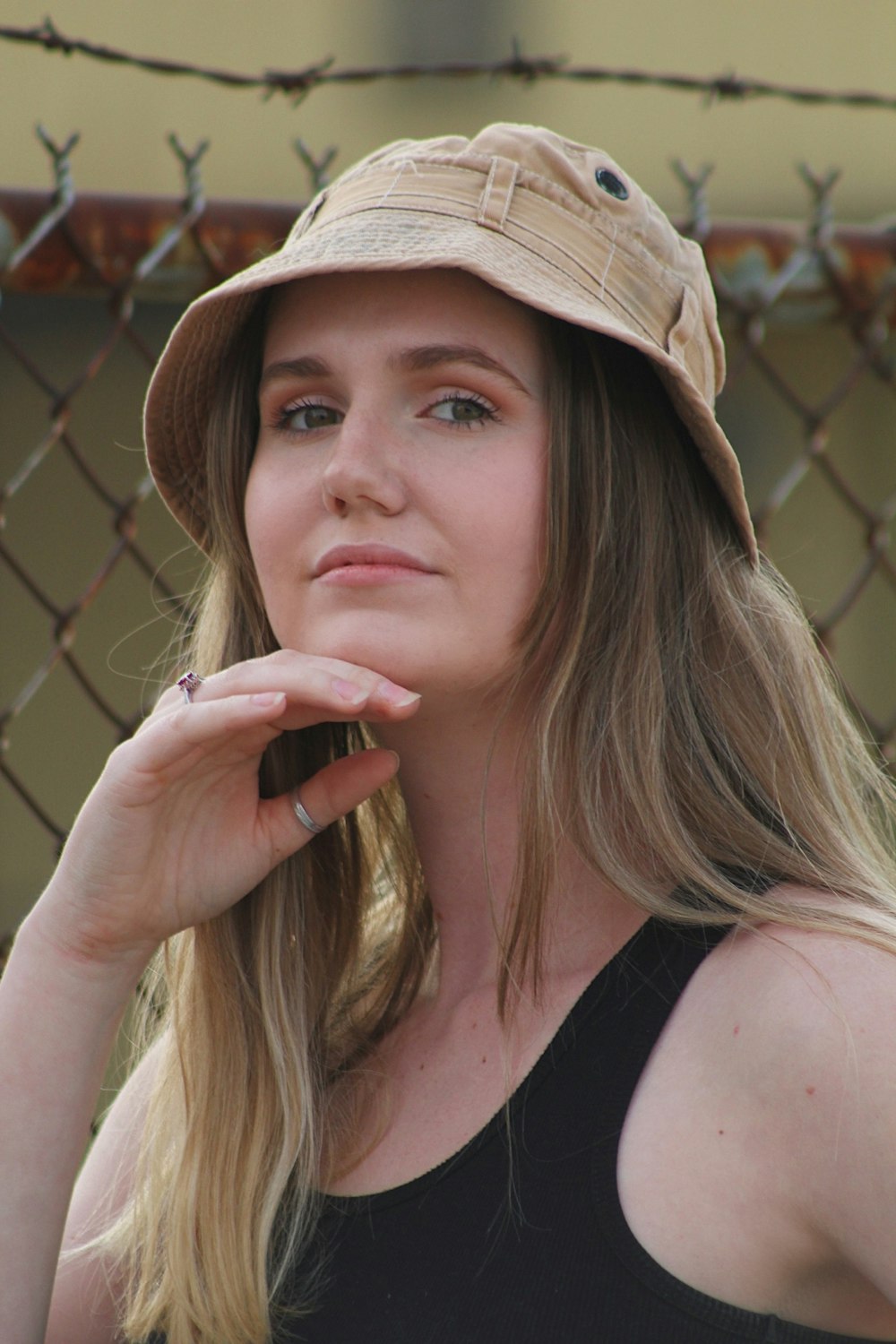woman in black tank top wearing brown hat