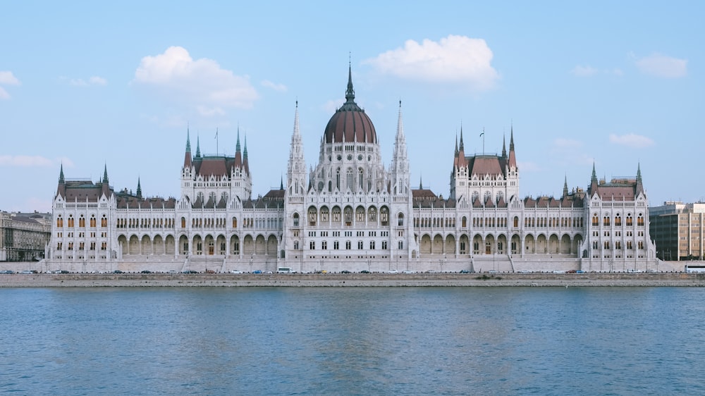 white and brown concrete building near body of water during daytime