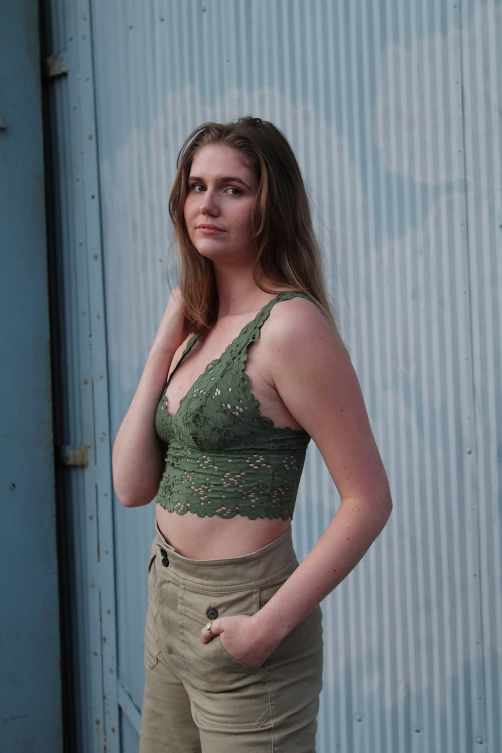 woman in green brassiere and gray shorts