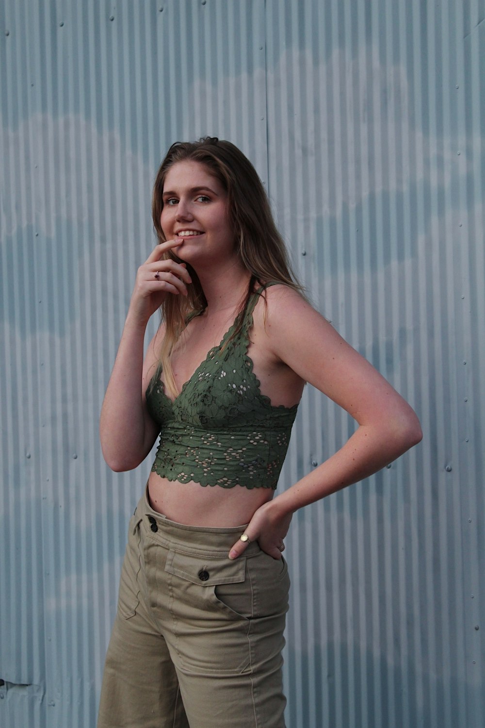 woman in green and black floral brassiere and gray pants