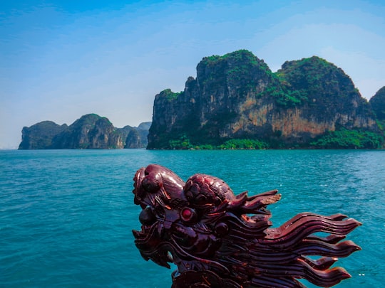 green and brown mountain beside sea during daytime in Phuket Thailand