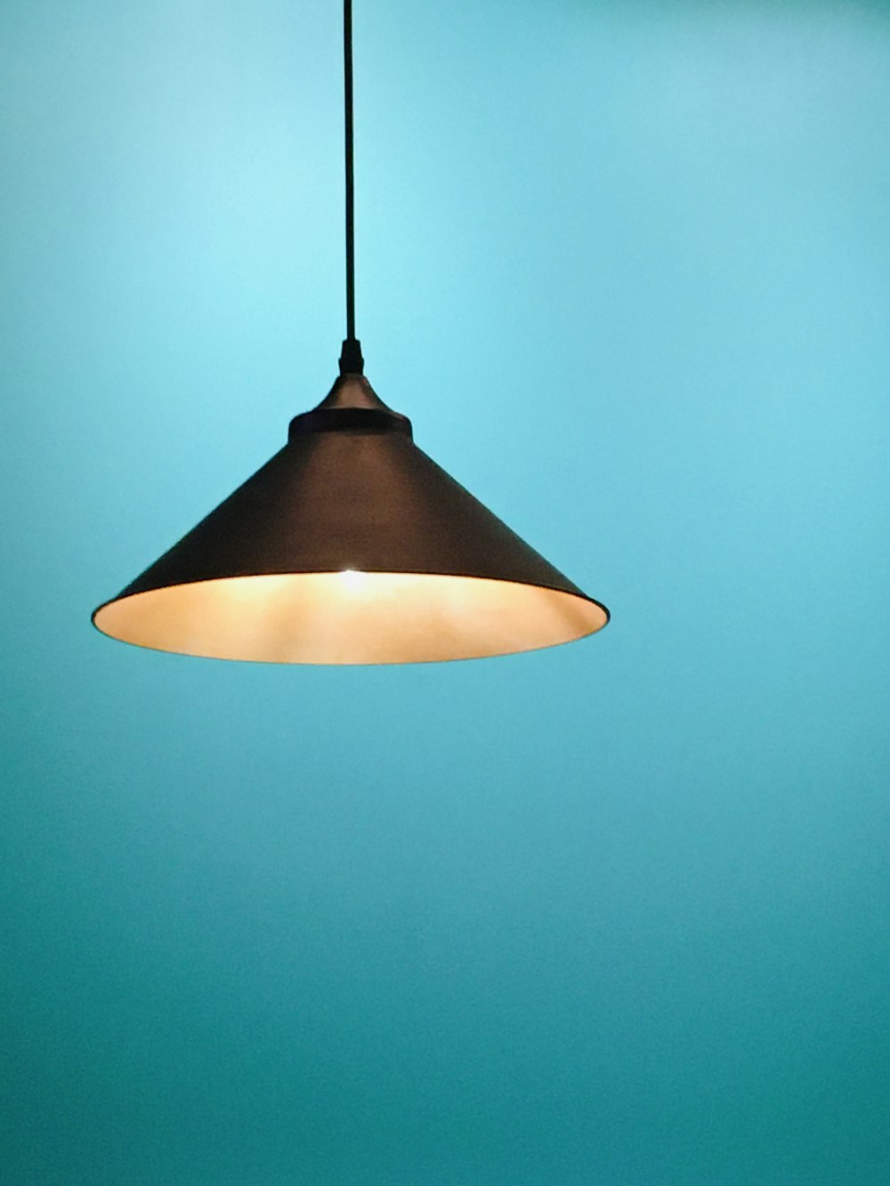 black pendant lamp turned on in room