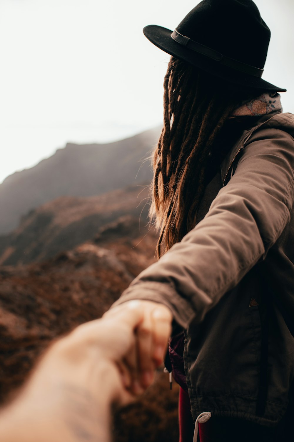 woman in black jacket holding her hand