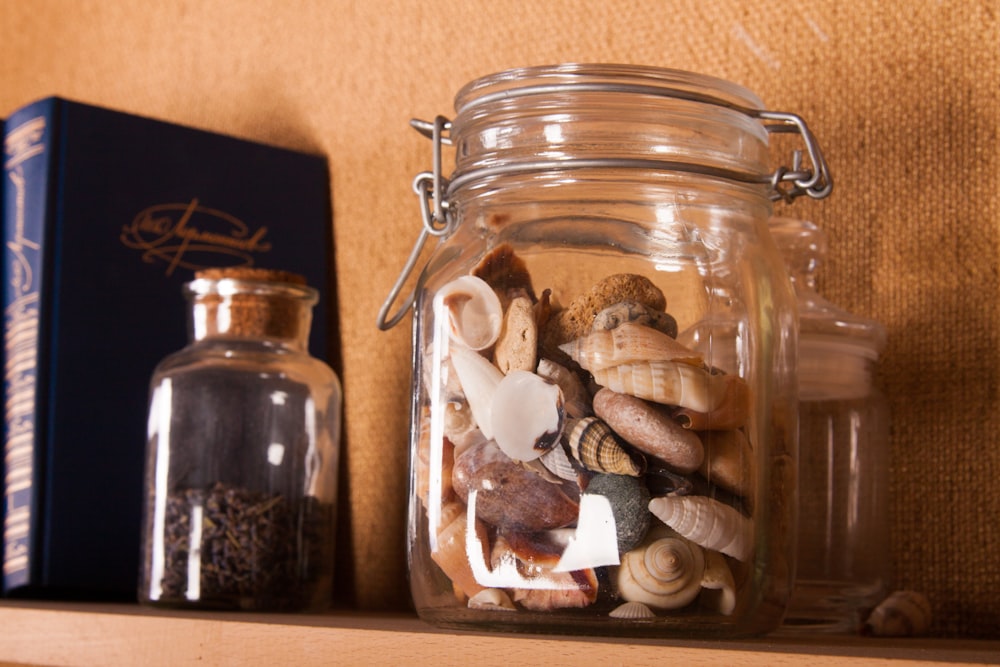 brown and white stones in clear glass jar