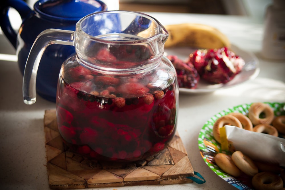 clear glass jar with red liquid inside