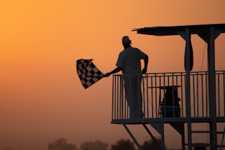 man in white shirt holding us a flag