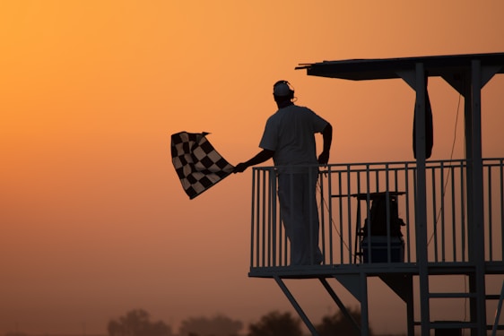 man in white shirt holding us a flag