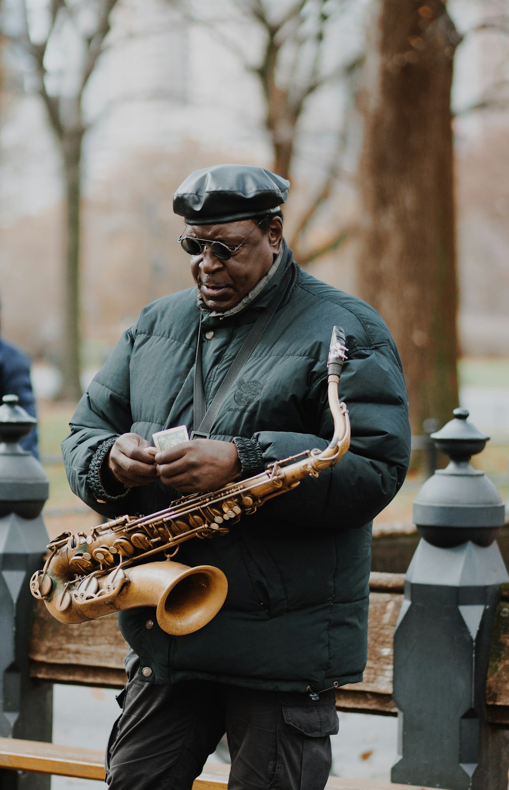 man in gray dress shirt playing saxophone