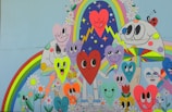 A colorful mural painted by community members depicting hearts and stars intertwined.
