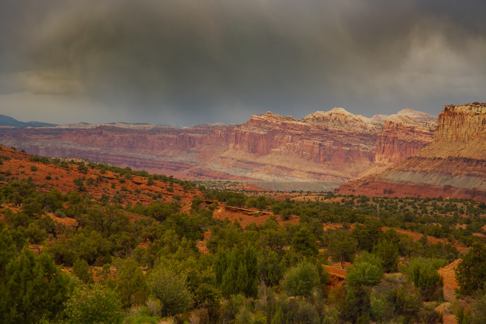 brown rocky mountain under gray sky