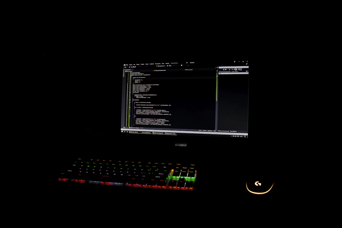 Black monitor with a dark terminal screen in a dim room