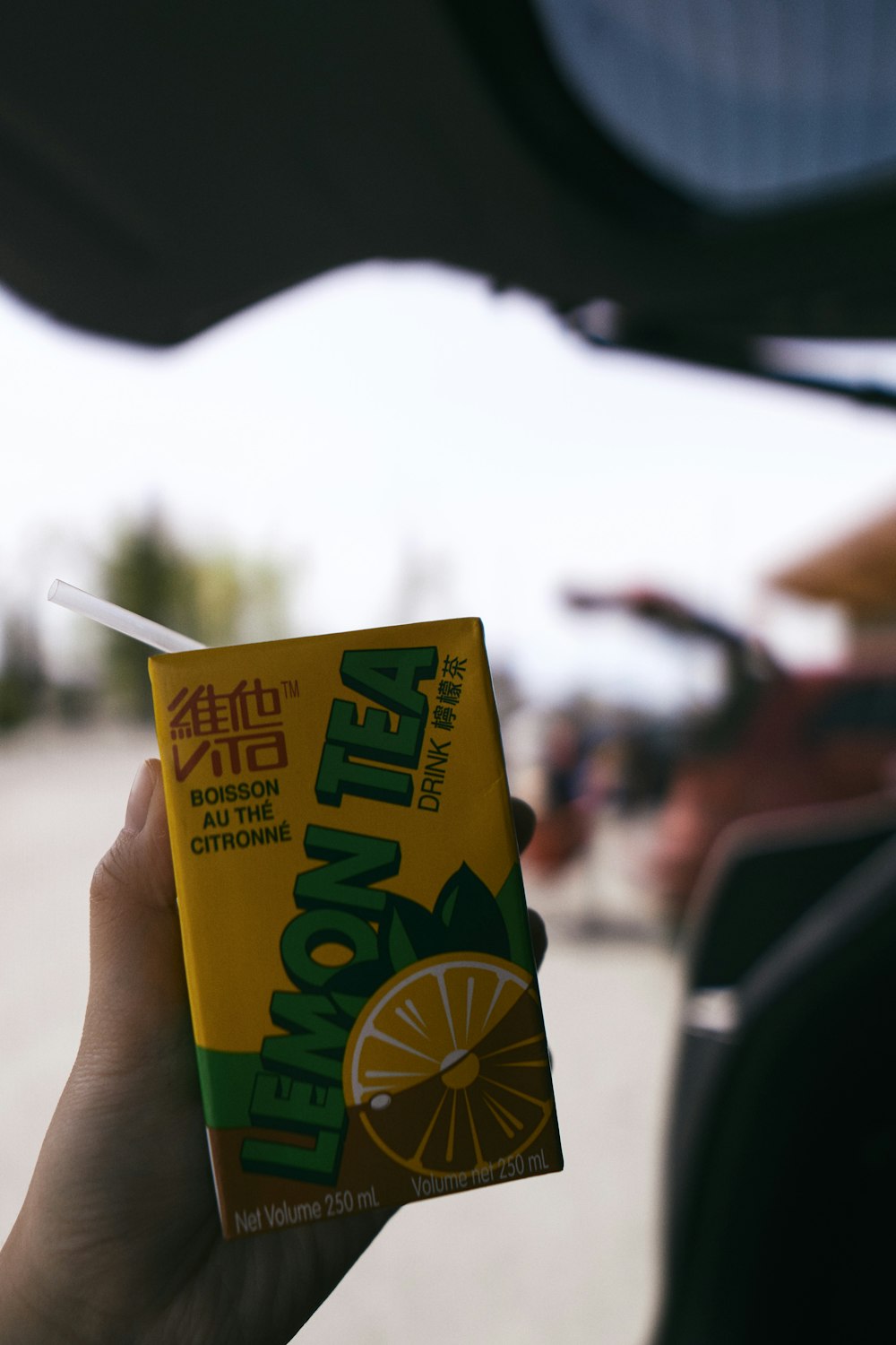 person holding yellow and green carton