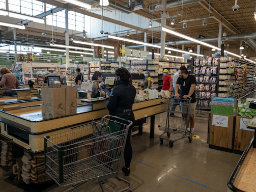 Community members shopping happily inside the cozy supermarket