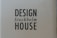 A cardboard background with the words 'DESIGN Stockholm HOUSE' printed in bold black letters.