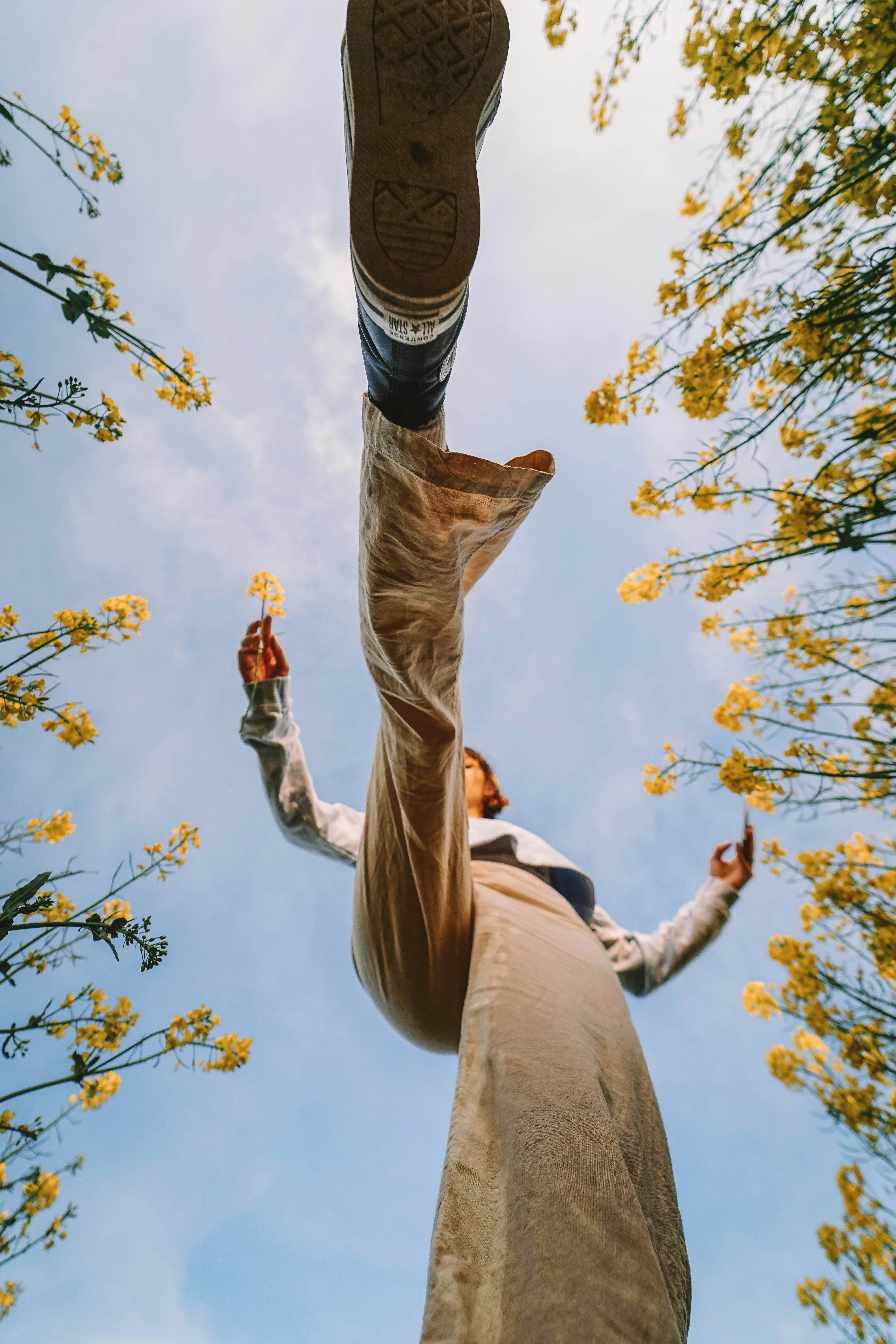 man in brown pants and black and white striped shirt jumping