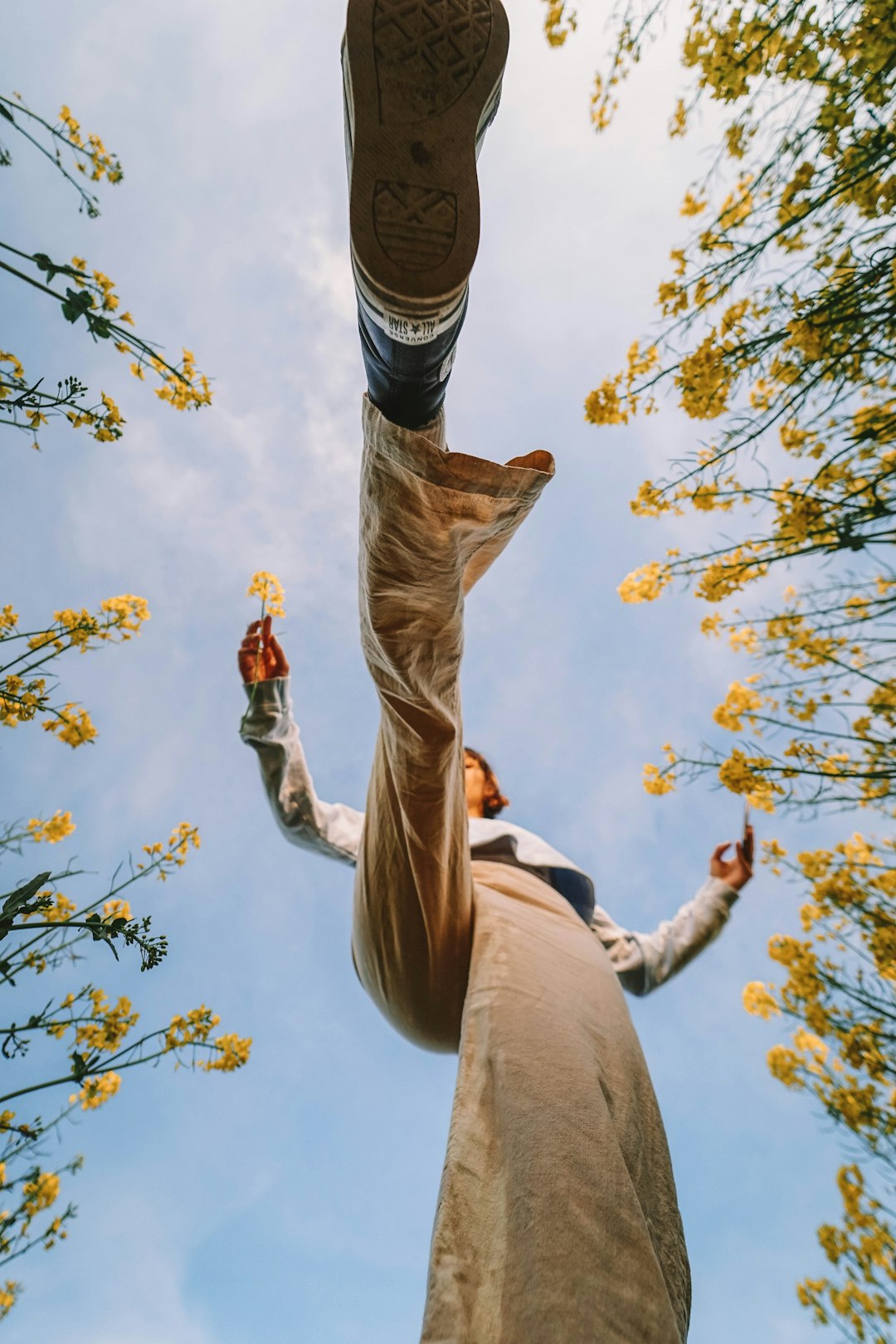 man in brown pants and black and white striped shirt jumping