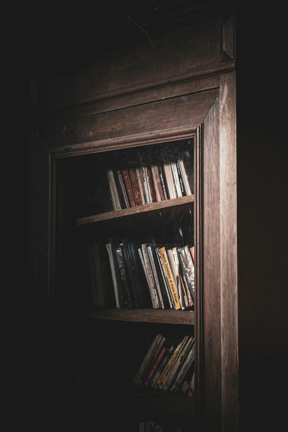 books on brown wooden shelf