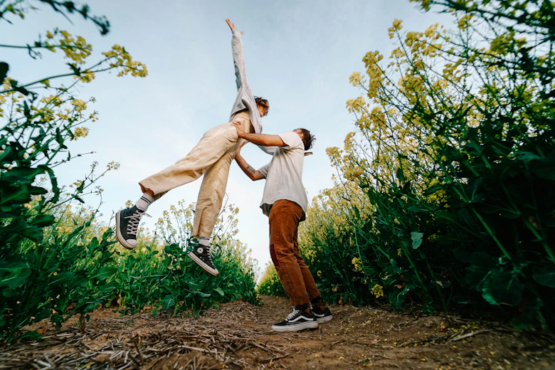 man in brown pants and black shoes standing on brown grass field during daytime