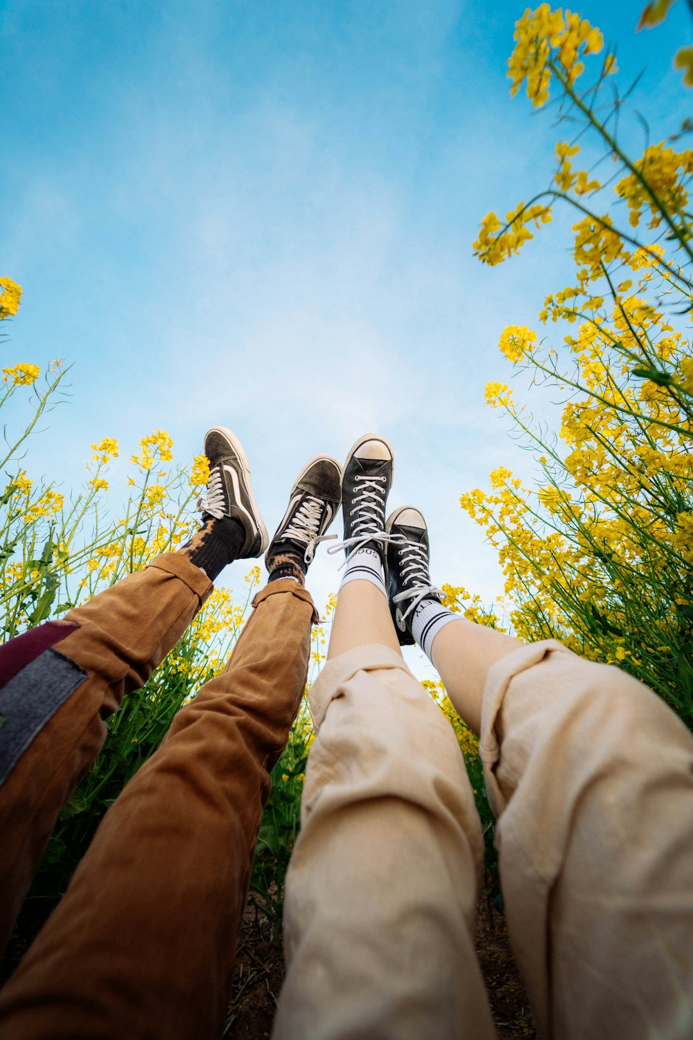 person in brown pants and black and white sneakers