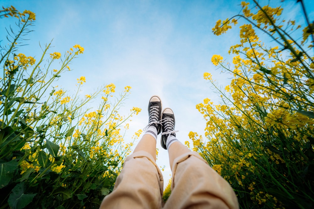 person in brown pants and black and white sneakers