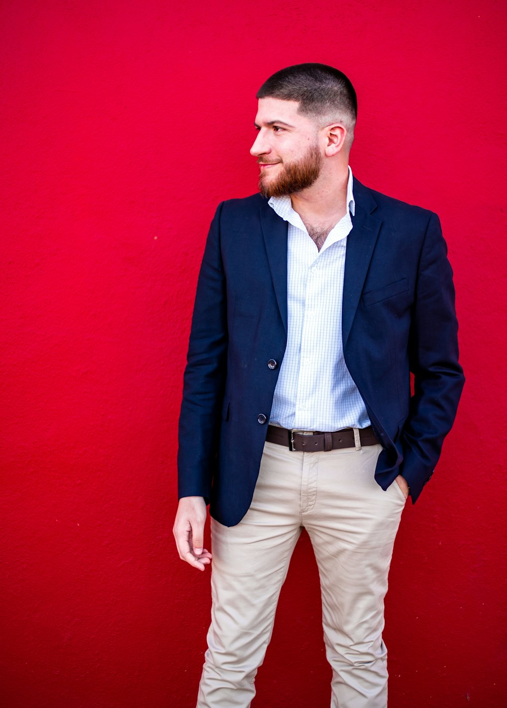 man in blue suit jacket and gray dress pants