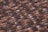 A detailed close-up view of a roof with rows of overlapping terracotta tiles. The tiles have a mix of brown and dark brown shades, giving them a weathered and slightly textured appearance.