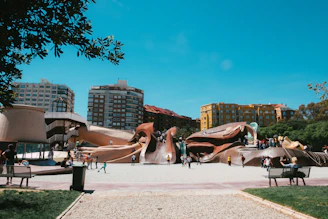 people sitting on bench near building during daytime