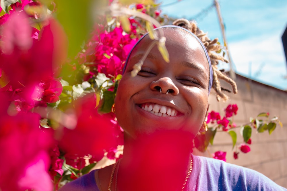 smiling girl in pink shirt with pink flower crown