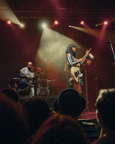 man in black t-shirt playing electric guitar on stage