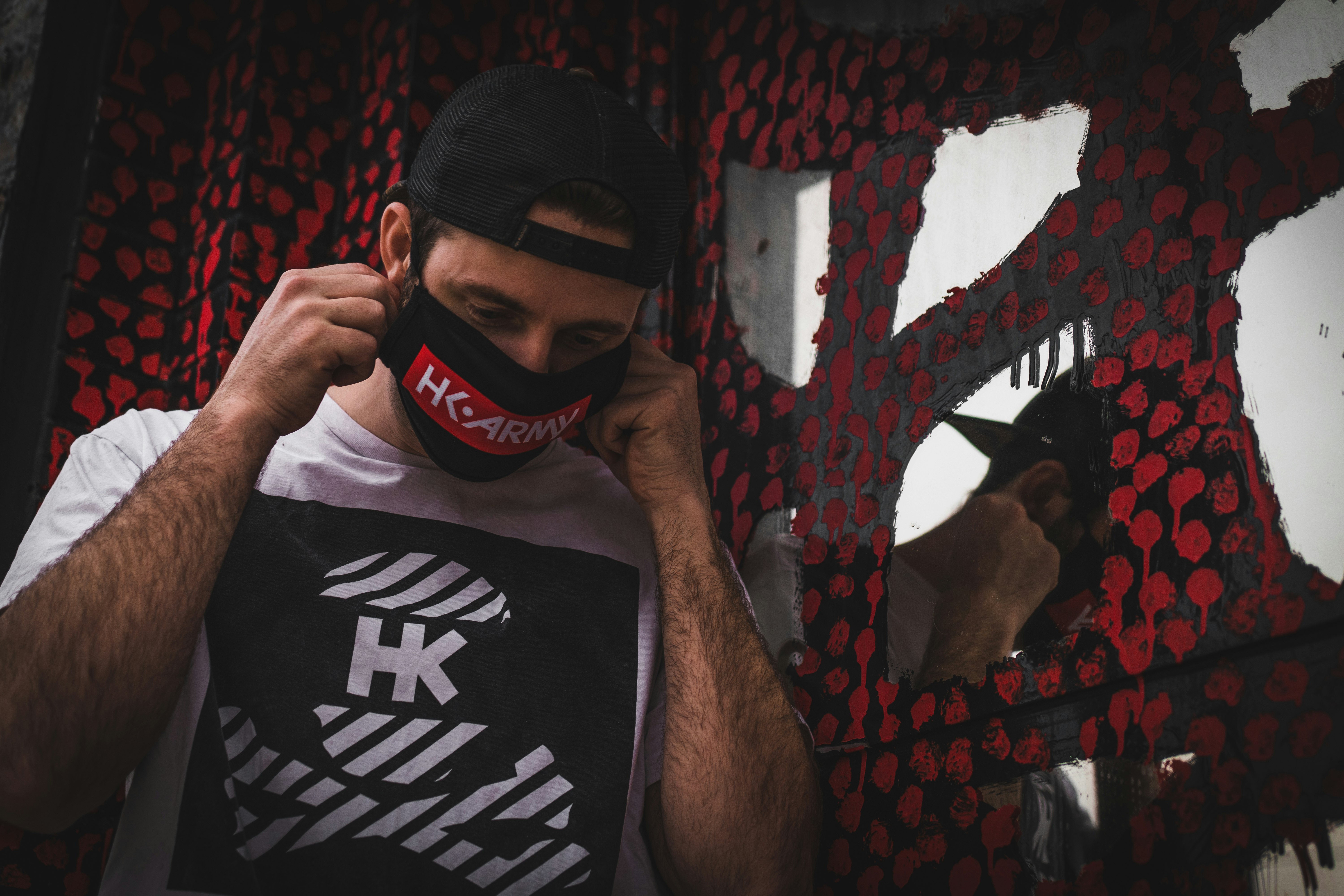 man in black and white tank top wearing black mask