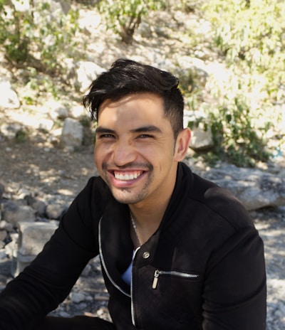 man in black zip up jacket smiling