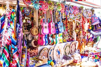 assorted color electric guitars on display