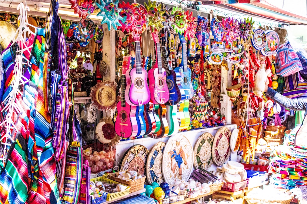 assorted color electric guitars on display