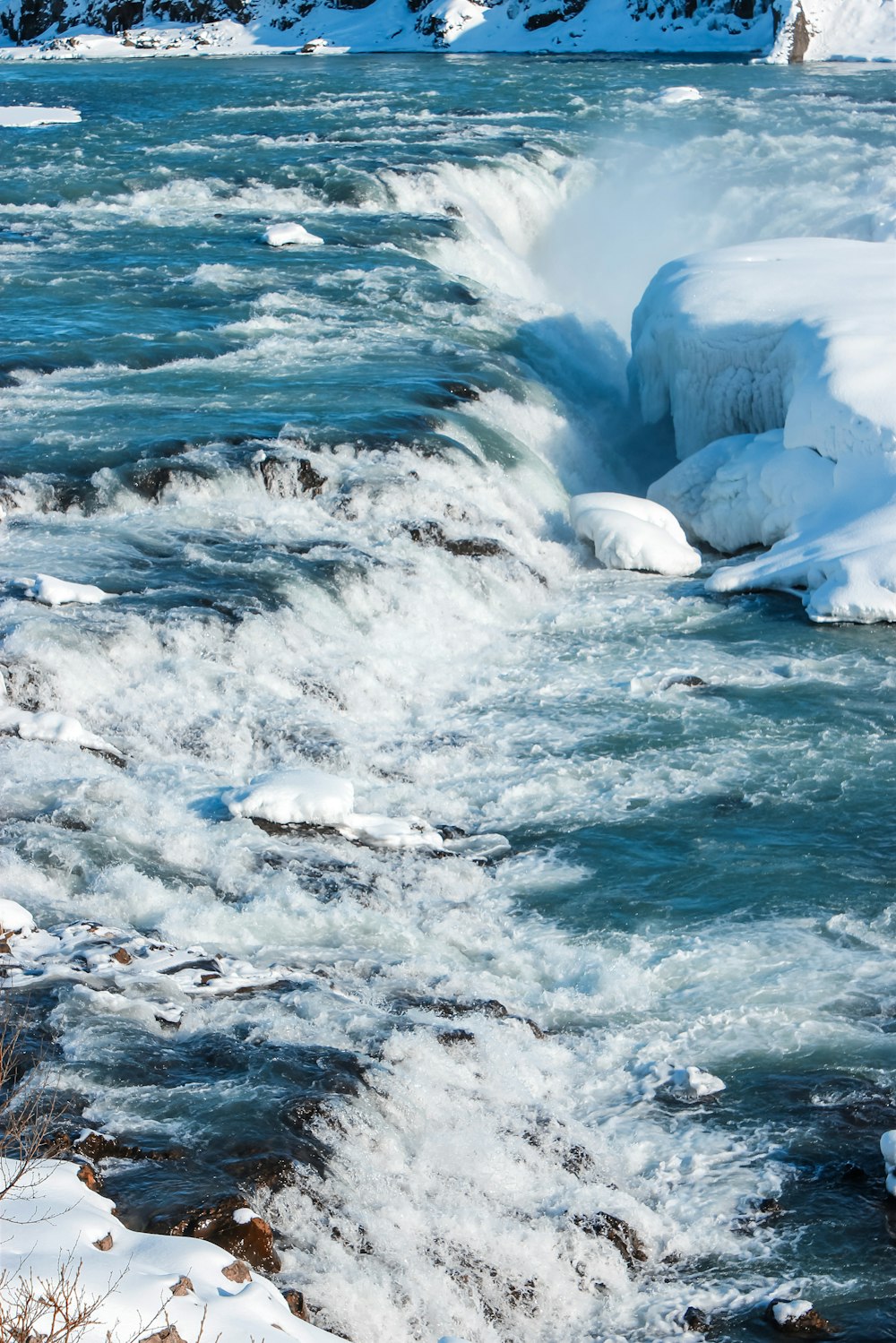 white ice on body of water during daytime