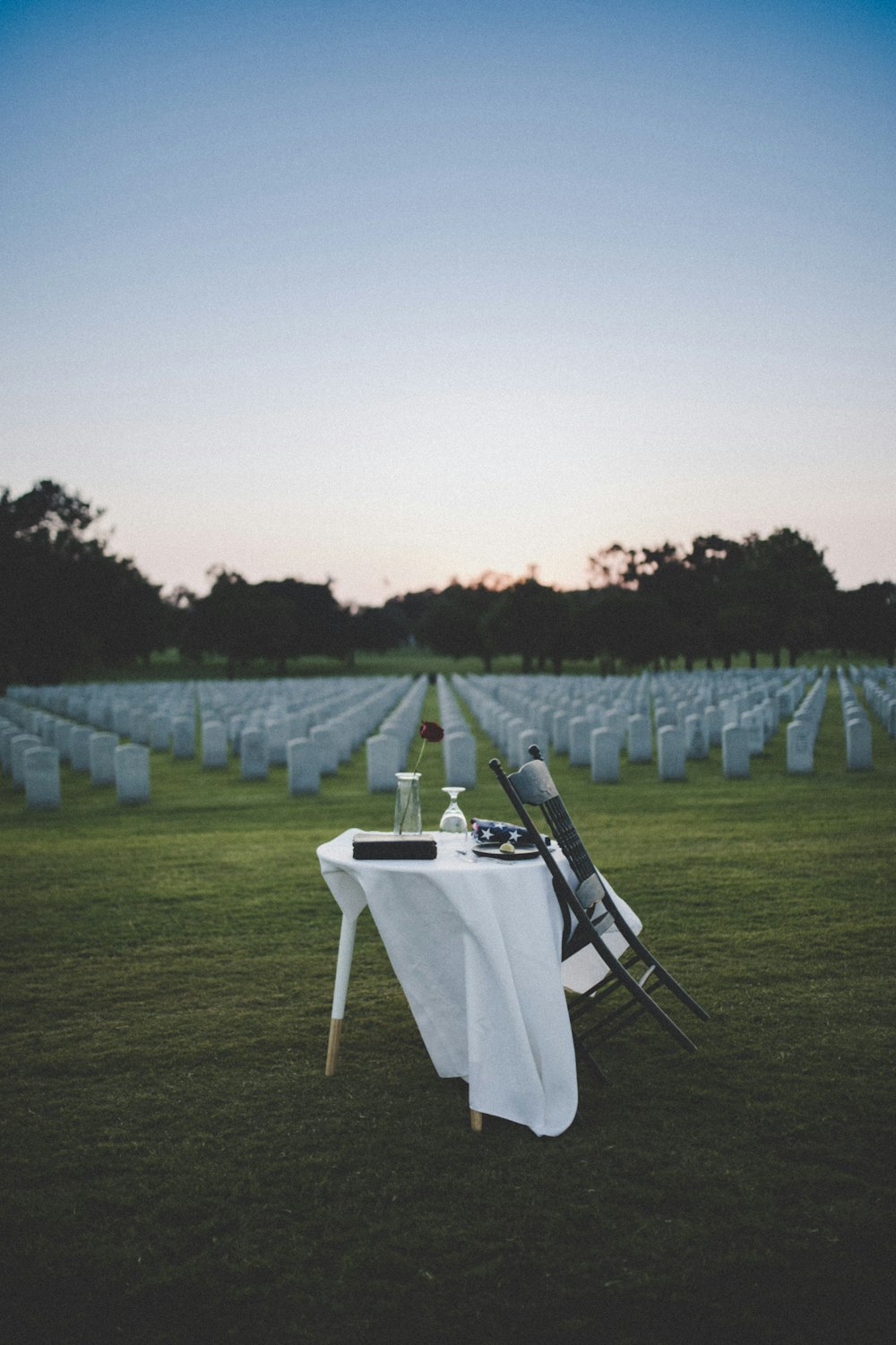 white and black folding chair on green grass field during daytime