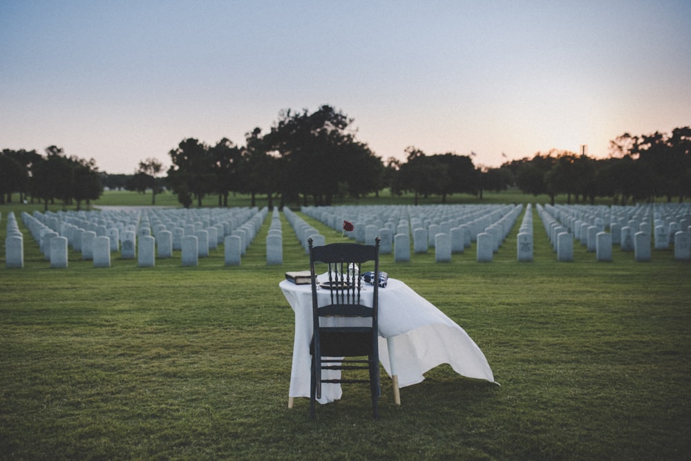 white table and chairs on green grass field