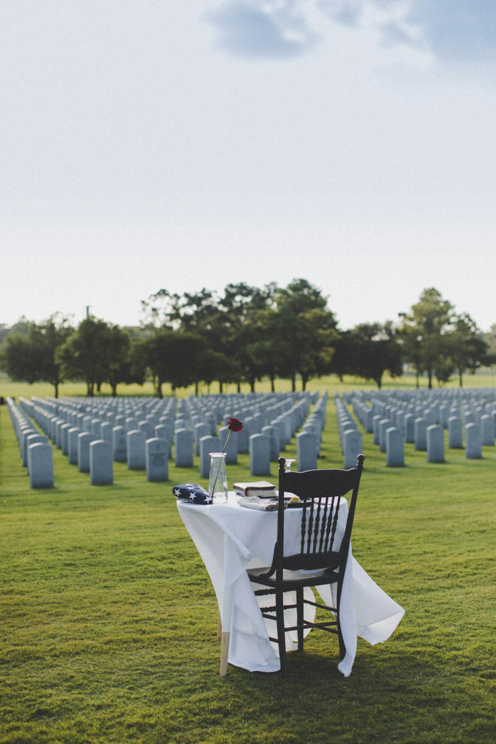white table and chairs on green grass field during daytime
