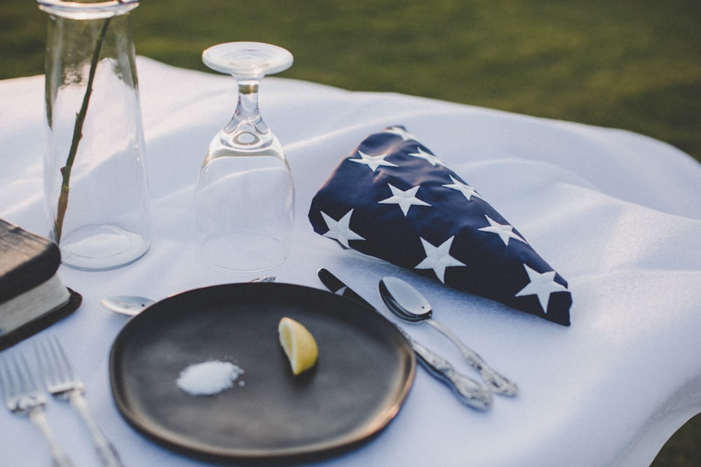 stainless steel fork and bread knife on white ceramic plate