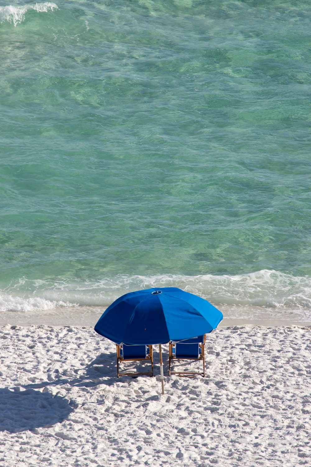 blue umbrella on beach during daytime