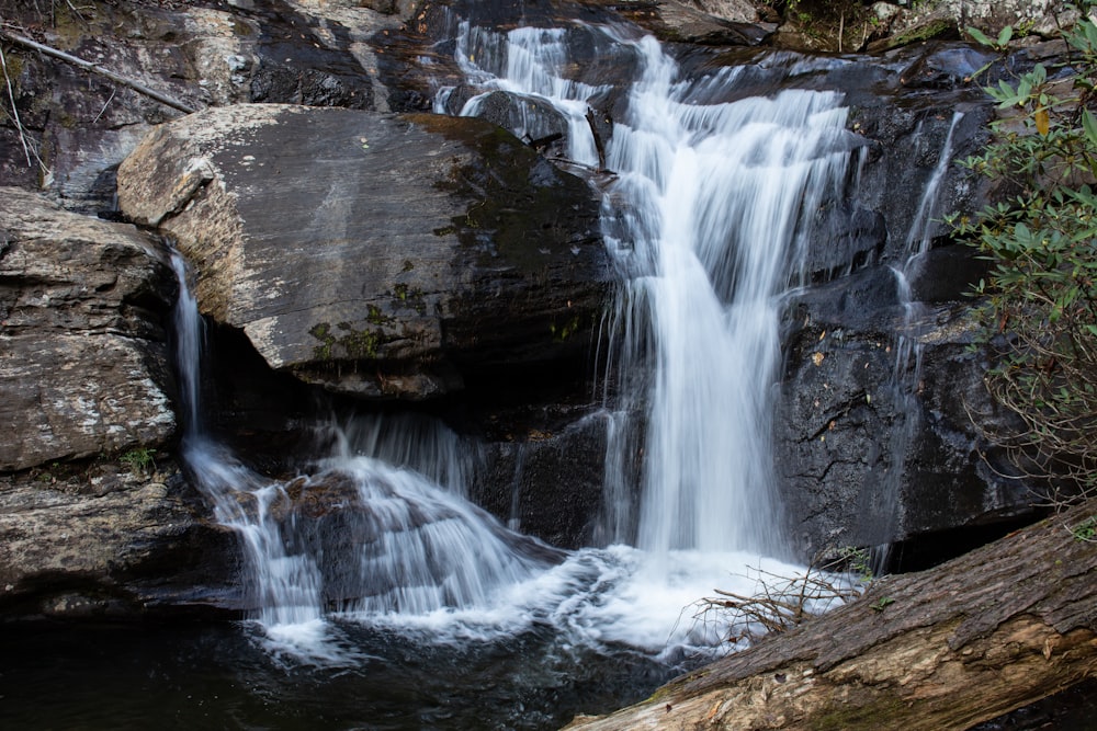 water falls on brown rock