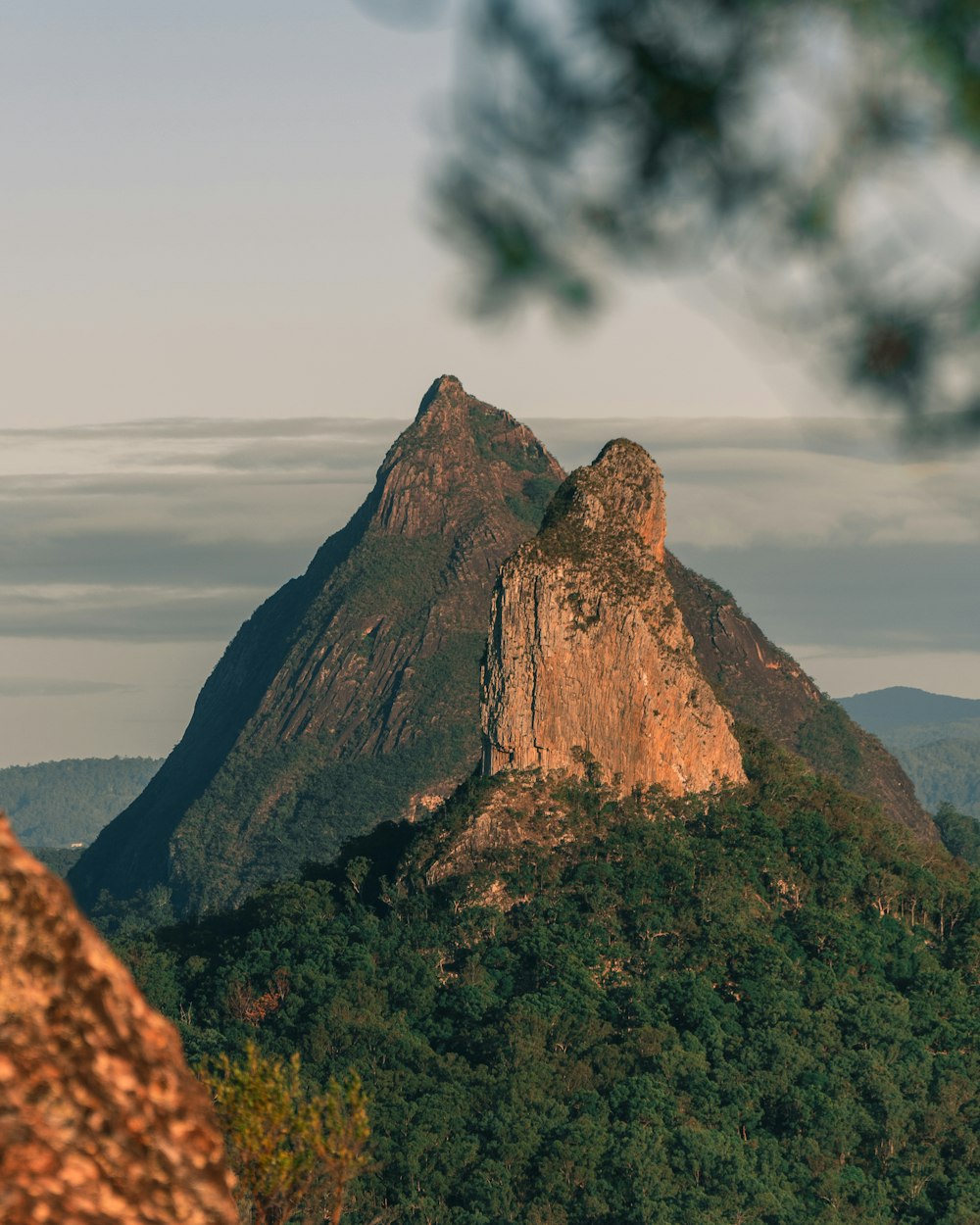 brown rock formation under white clouds during daytime