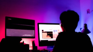 A futuristic workspace with glowing screens and a person analyzing data.